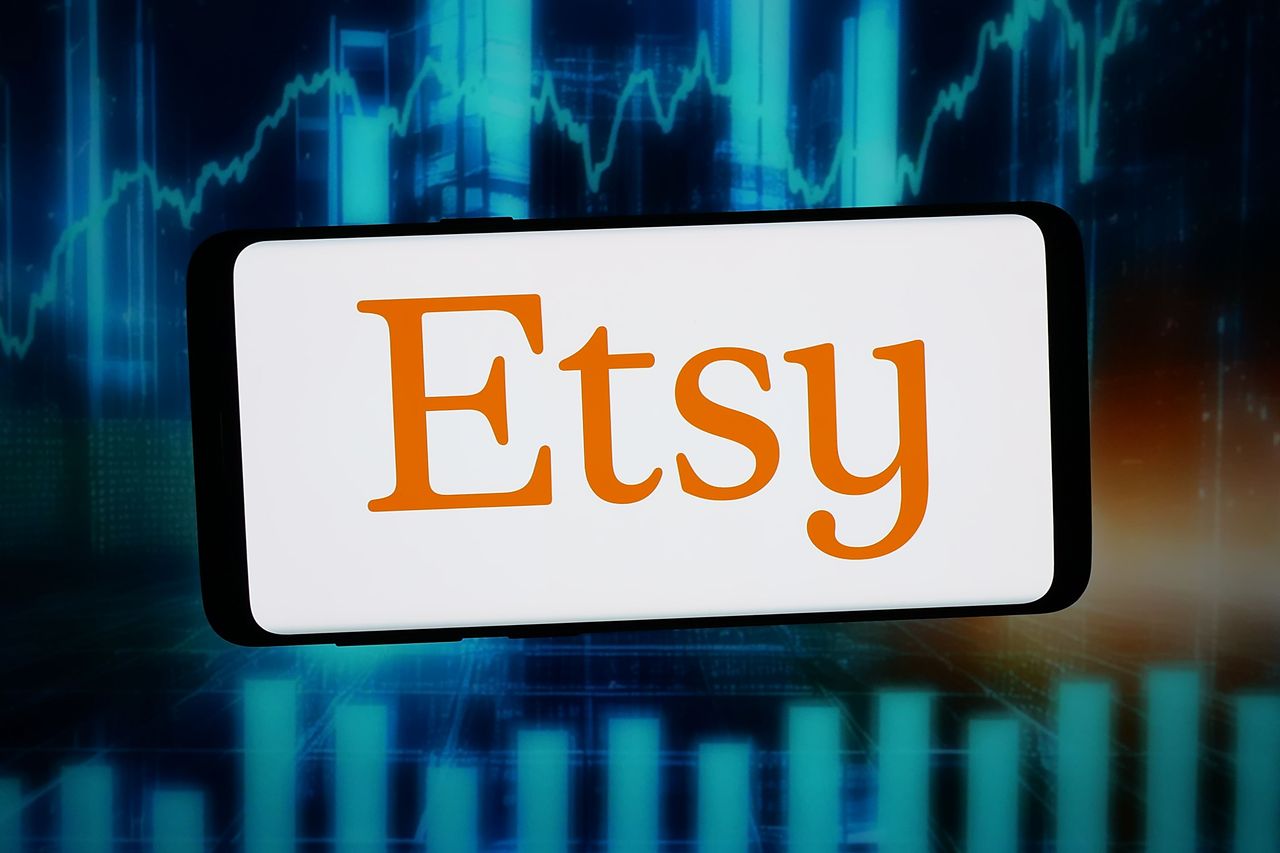 The logo of US e-commerce company Etsy Inc. is displayed on a smartphone in front of abstract background on computer screen. (Photo Illustration by Timon Schneider/SOPA Images/LightRocket via Getty Images)