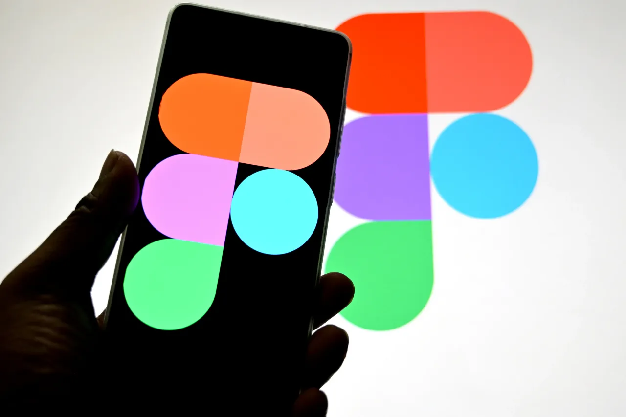 In this photo illustration, the Figma logo is displayed on a smartphone, with the background visible.