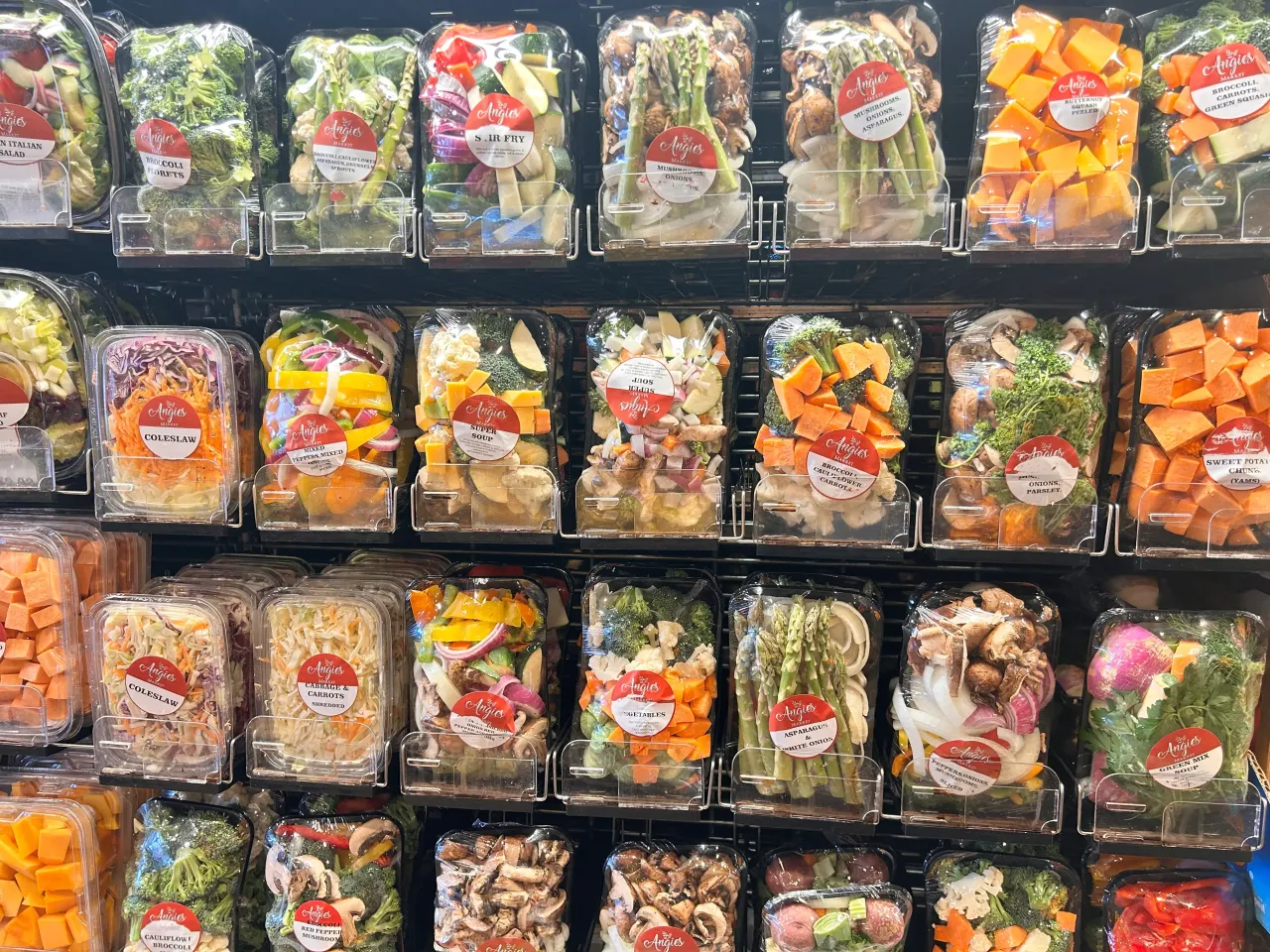 Pre-cut and pre-packaged veggies in produce aisle of supermarket, Queens, New York.