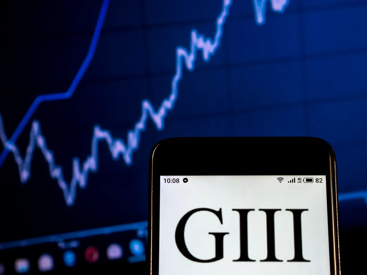 In this photo illustration, the G-III Apparel Group Clothing company logo seen displayed on a smartphone.