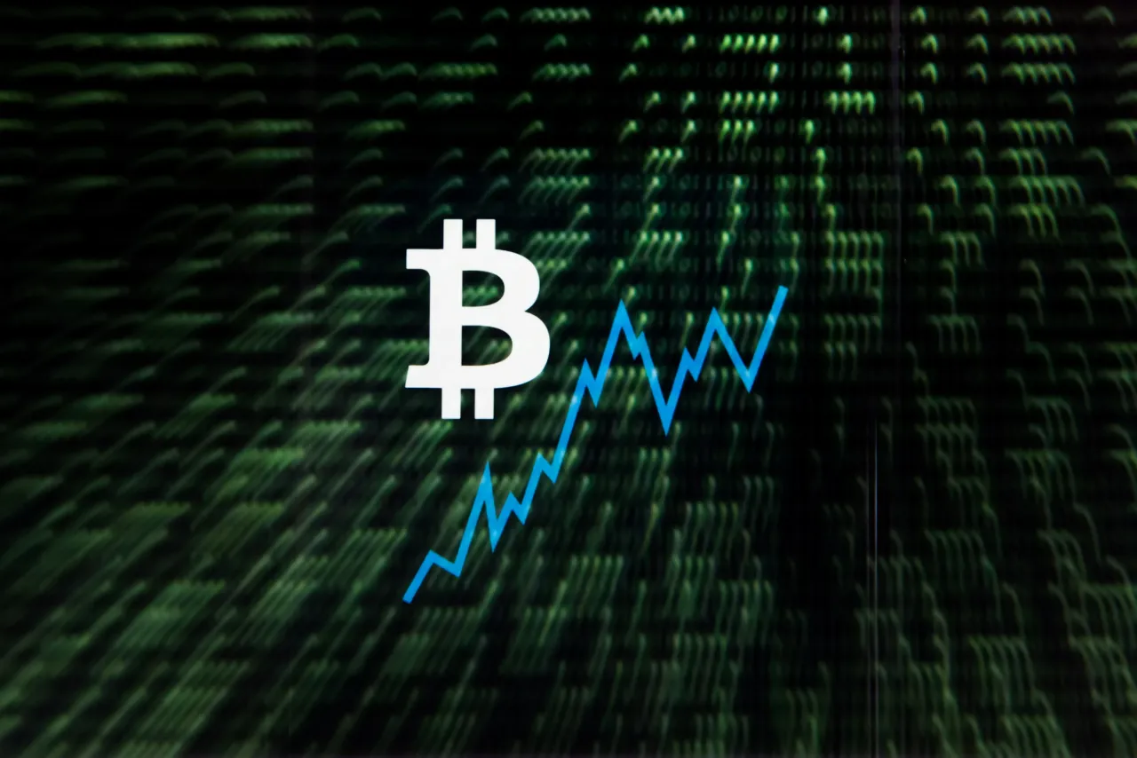 In this photo illustration a double exposure image shows the bitcoin logo and coding. (Photo illustration by Omar Marques/SOPA Images/LightRocket via Getty Images)