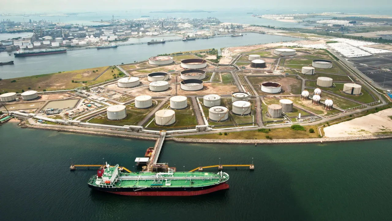 An oil tanker and a tank at the loading dock, Petrochemical Refinery, Jurong Island, Singapore.