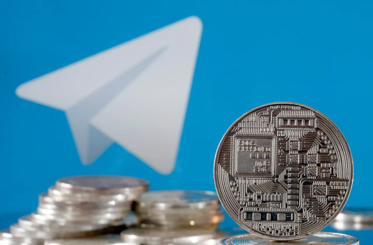 In this photo illustration, a visual representation of digital cryptocurrency coins is displayed in front of the Telegram messaging logo.