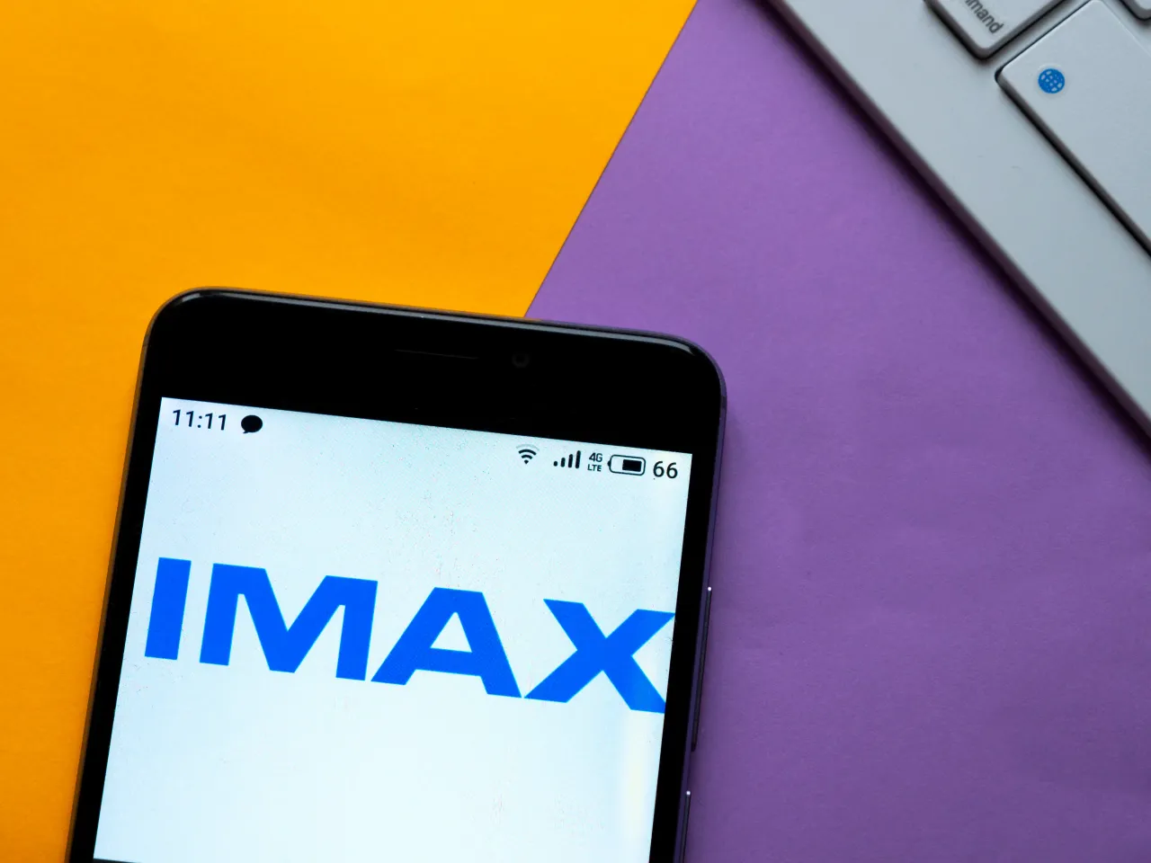 In this photo illustration the IMAX logo is seen displayed on a smartphone. 