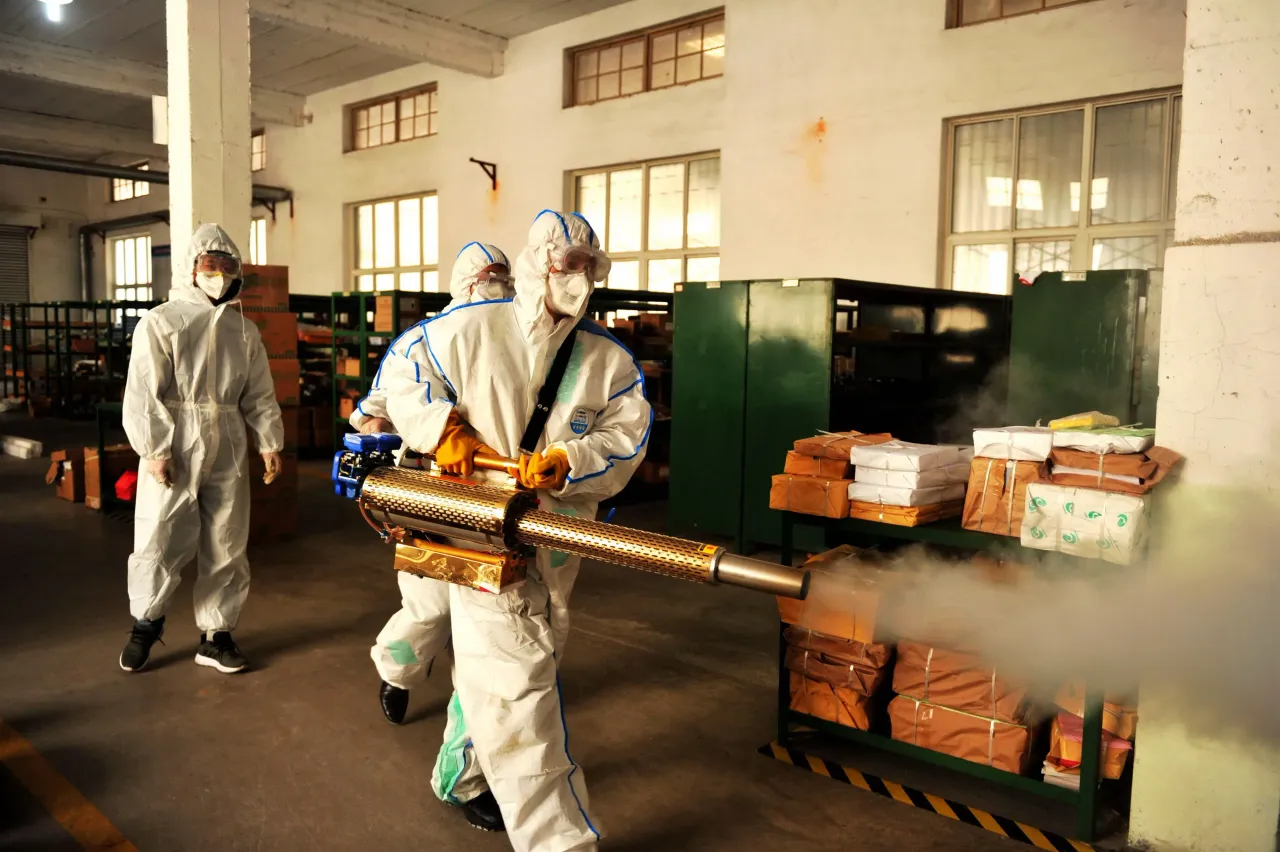  Volunteers spray medicine to disinfect the comprehensive warehouse of the enterprise, Qingdao, Shandong Province, China.
