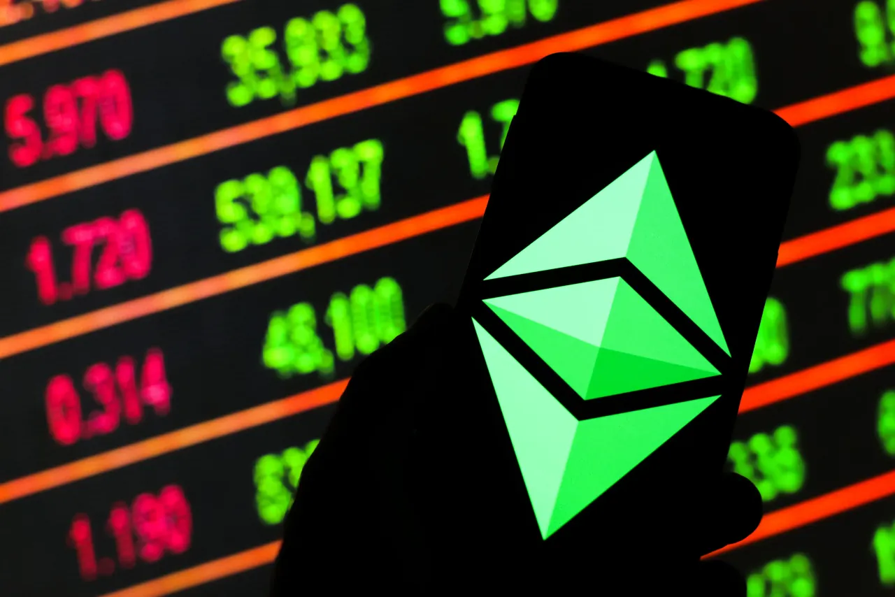 In this photo illustration an Ethereum, cryptocurrency logo seen displayed on a smartphone. Stock market prices in the background as stock markets tumble all over the world. (Photo by Filip Radwanski/SOPA Images/LightRocket via Getty Images)