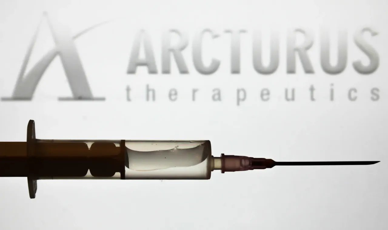 Medical syringe is seen with Arcturus Therapeutics company logo displayed on a screen in the background in this illustration photo taken in Poland on June 16, 2020. (Photo Illustration by Jakub Porzycki/NurPhoto via Getty Images)