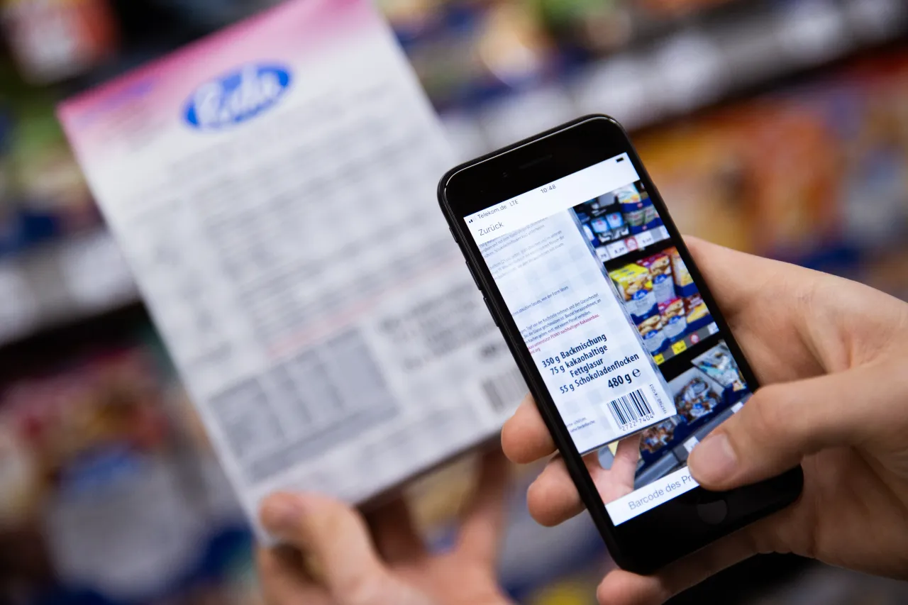 A consumer scanning a product in a mobile app at a retail store. (Photo by Rolf Vennenbernd/picture alliance via Getty Images)