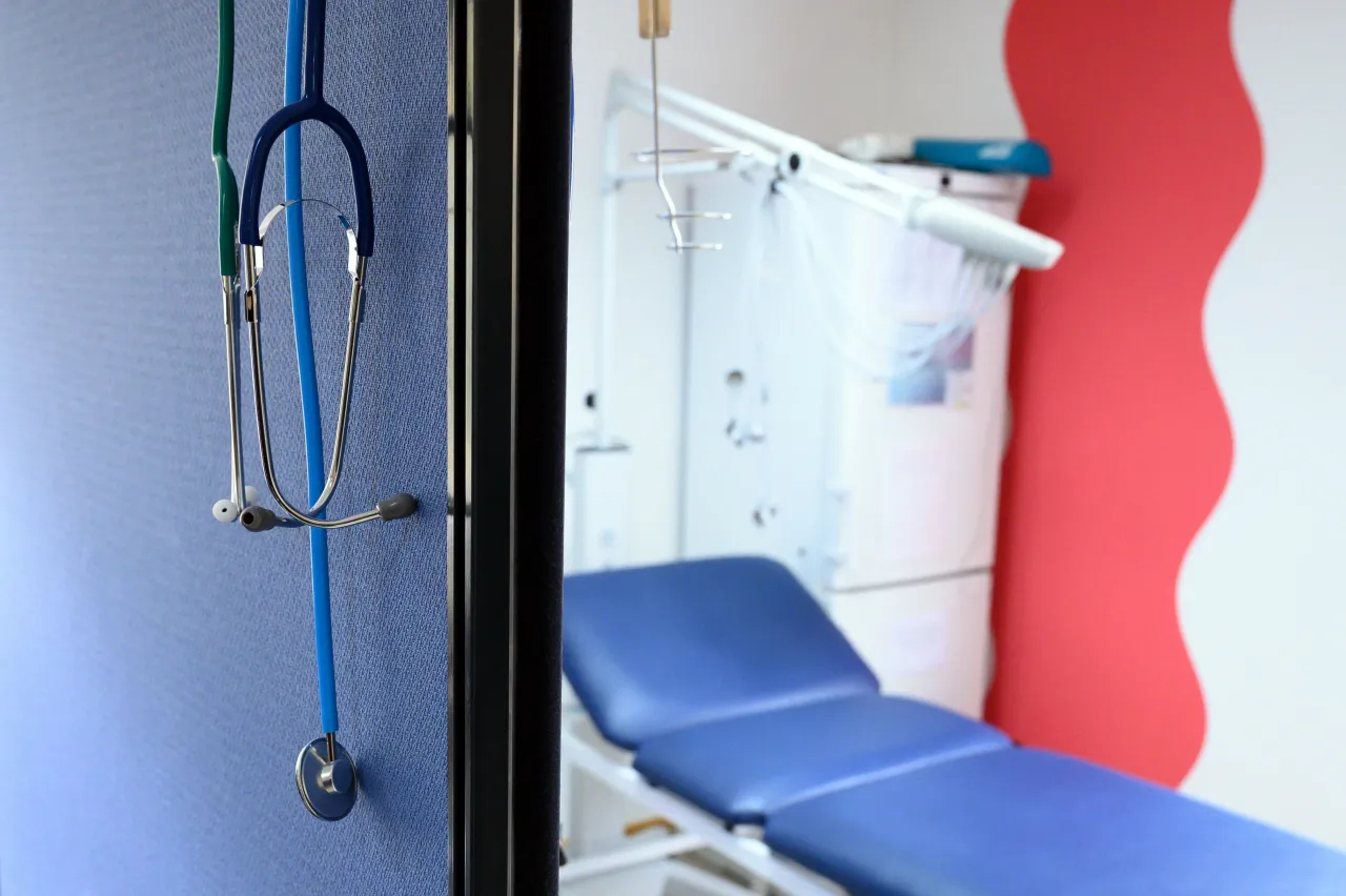 Stethoscopes hang above a partition in a medical room. (Photo by Sebastian Kahnert/picture alliance via Getty Images)
