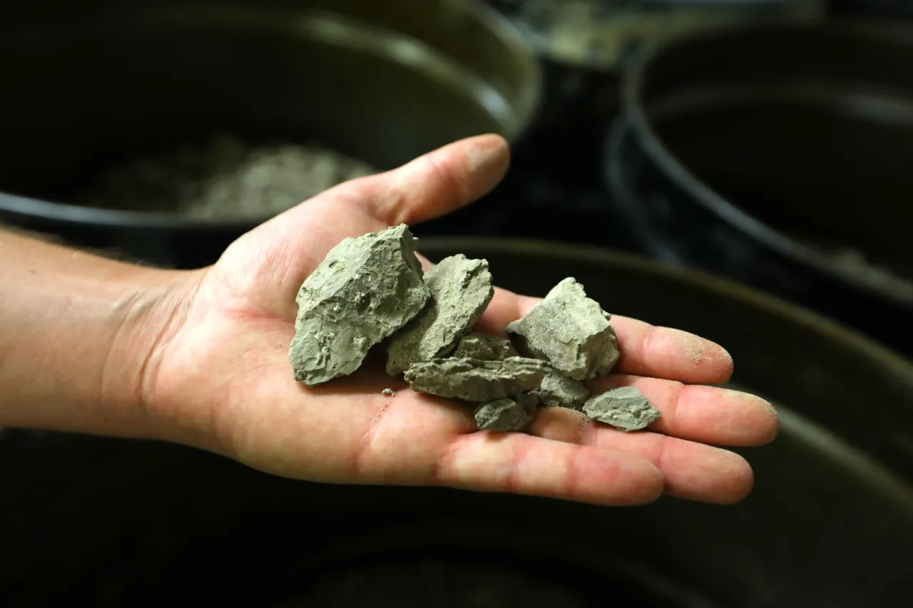 The clay mixture from which lithium will be extracted is held by Tim Crowley, spokesman for Lithium Americas Corp. (Carolyn Cole / Los Angeles Times via Getty Images)
