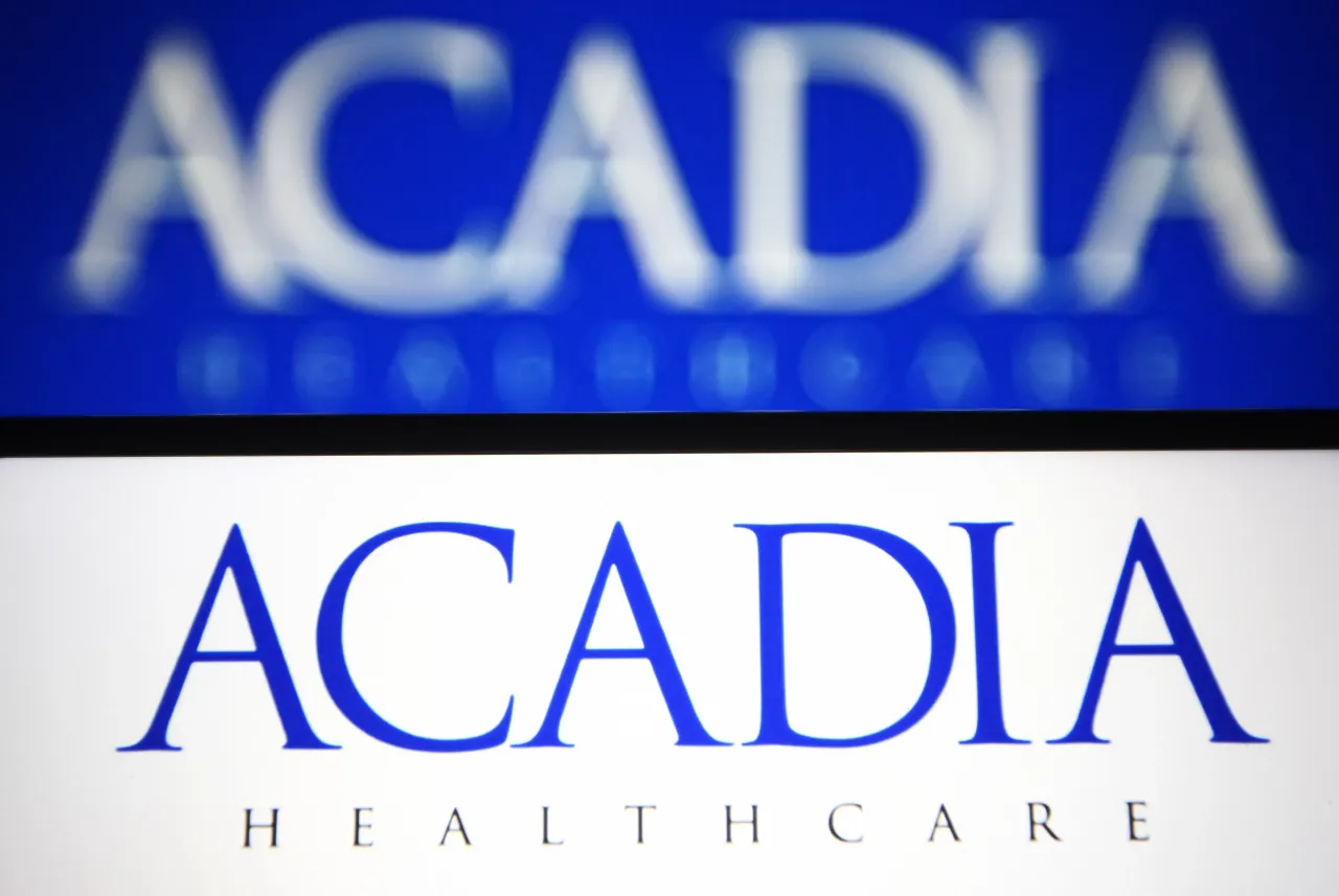 In this photo illustration an Acadia Healthcare logo is seen on a smartphone and a pc screen. (Photo Illustration by Pavlo Gonchar/SOPA Images/LightRocket via Getty Images)