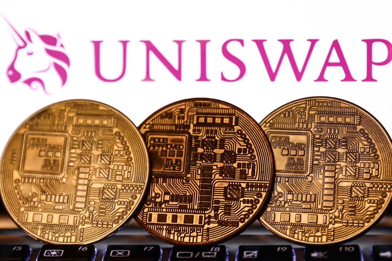 Uniswap logo displayed on a phone screen and representation of cryptocurrency are seen in this illustration photo taken in Krakow, Poland on November 6, 2021. (Photo by Jakub Porzycki/NurPhoto via Getty Images)