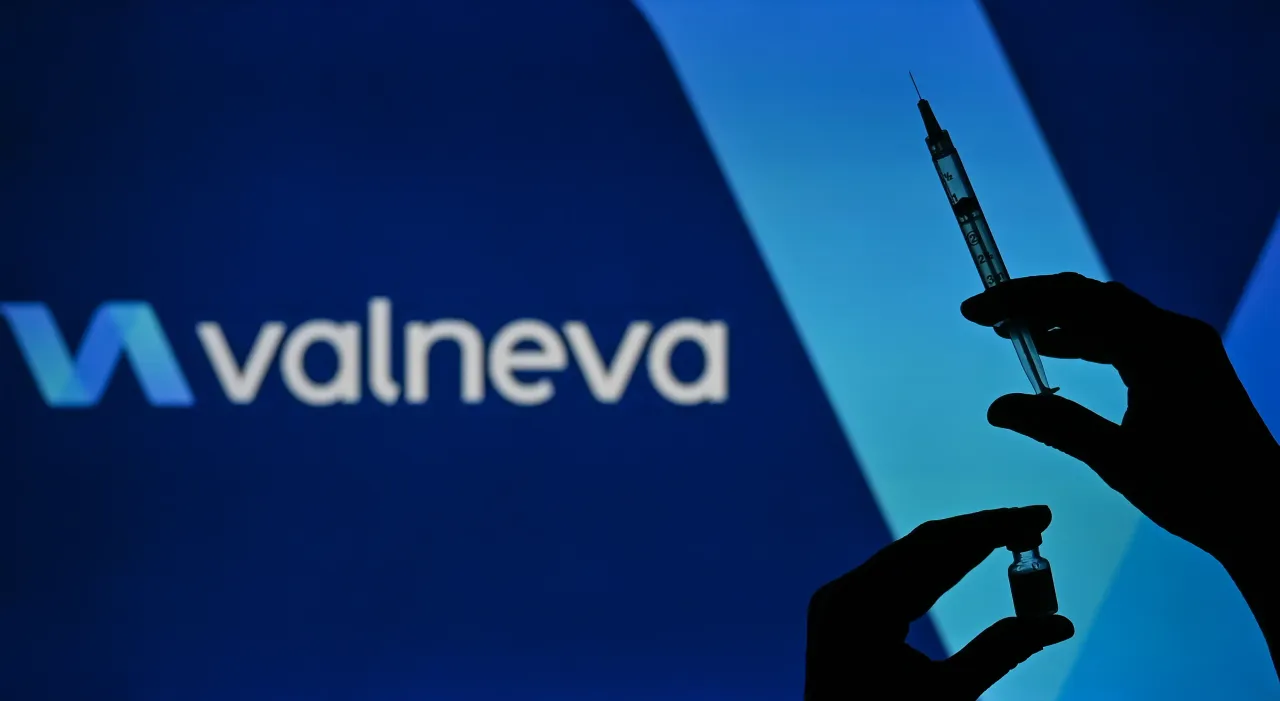 An illustrative image of a person holding a medical syringe and a Covid-19 vaccine vial in front of the the Valneva logo displayed on a screen. On Wednesday, January 12, 2021, in Edmonton, Alberta, Canada. (Photo by Artur Widak/NurPhoto via Getty Images)