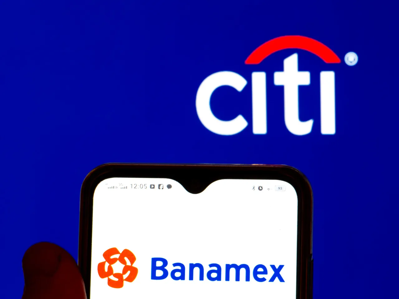 In this photo illustration, the Grupo Financiero Banamex, S.A. de C.V logo is displayed on a smartphone screen with a Citigroup Inc. logo in the background.