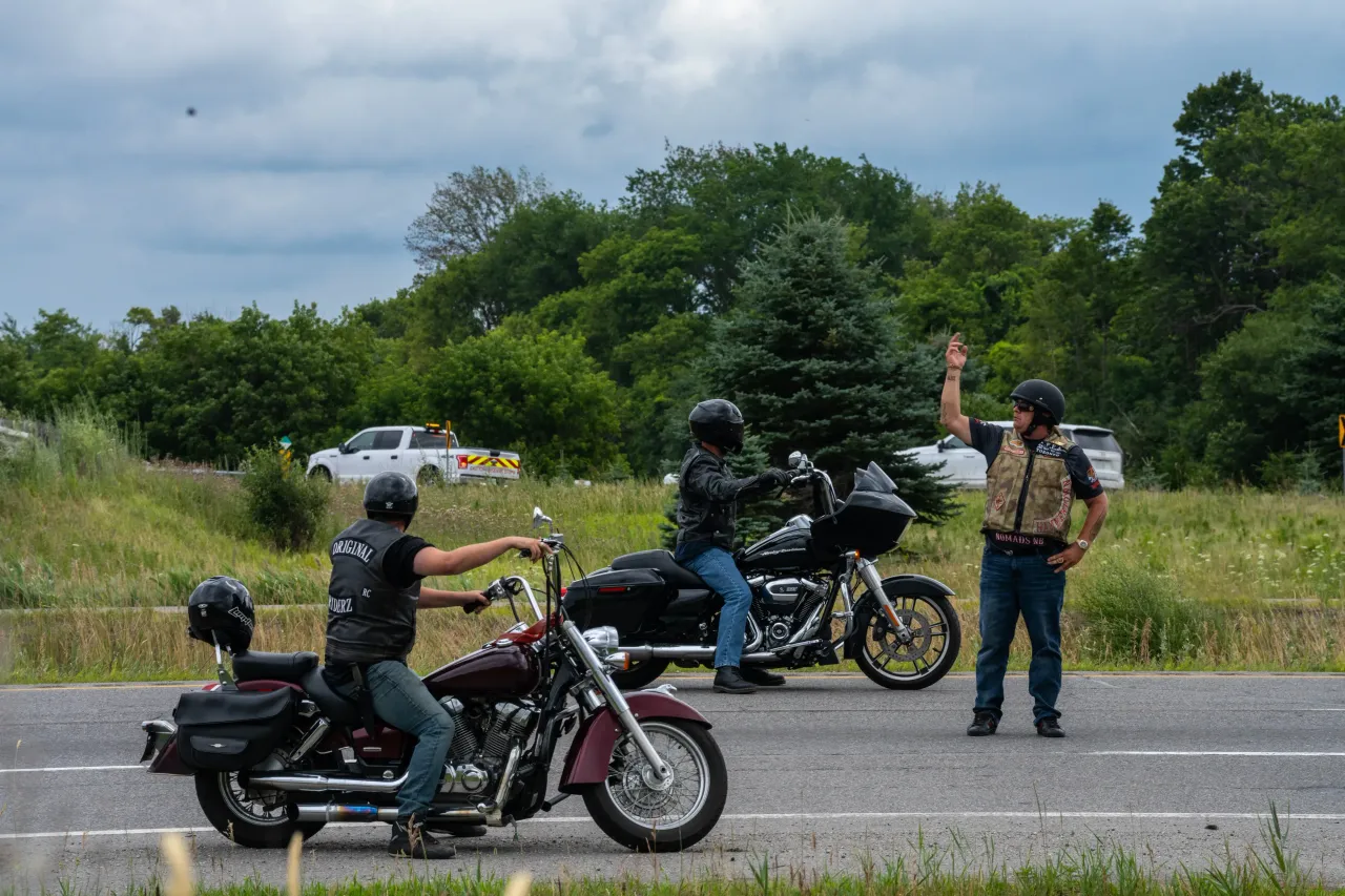 A member of the Hells Angels directs traffic along the highway after a fellow member got into an accident, pictured in August 2022. (Photo by Katherine Cheng/SOPA Images/LightRocket via Getty Images)