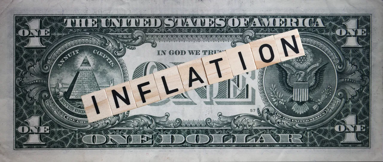 US Economy Illustrations Word 'Inflation' is written with wood tile letters arranged on US one dollar note for illustration photo in Krakow, Poland, on November 6, 2022. (Photo by Beata Zawrzel/NurPhoto via Getty Images)