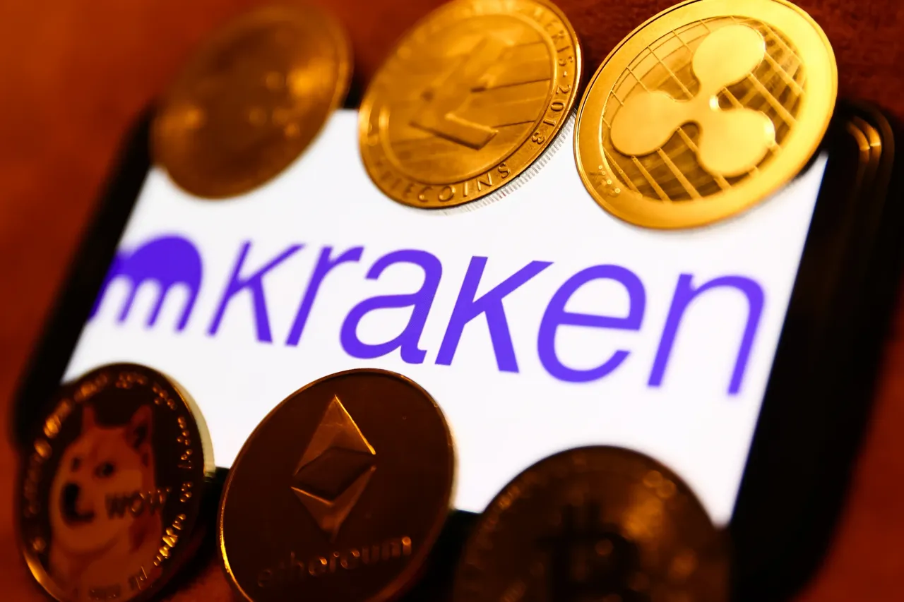 Kraken logo displayed on a phone screen and representation of cryptocurrencies are seen in this illustration photo taken in Krakow, Poland on January 29, 2023. 