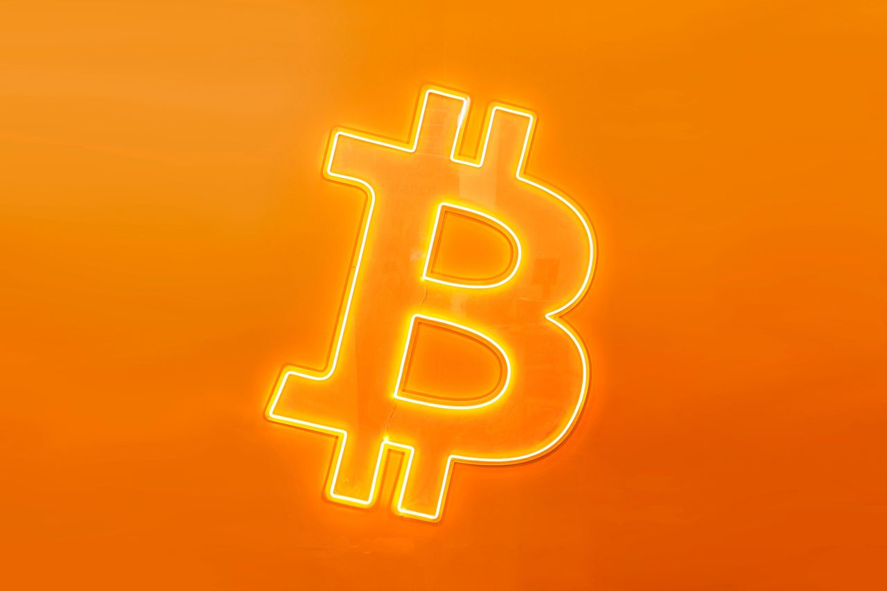 The Bitcoin symbol, the largest cryptocurrency by market cap that operates free of any central control and that relies on a peer-to-peer software and cryptography, on a luminous banner on the BitBase stand during the Mobile World Congress 2023 on March 10, 2023, in Barcelona, Spain. (Photo by Joan Cros/NurPhoto via Getty Images)