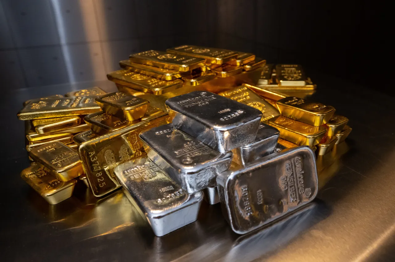 Gold and silver bars of various sizes lie in a safe on a table at the precious metals dealer Pro Aurum