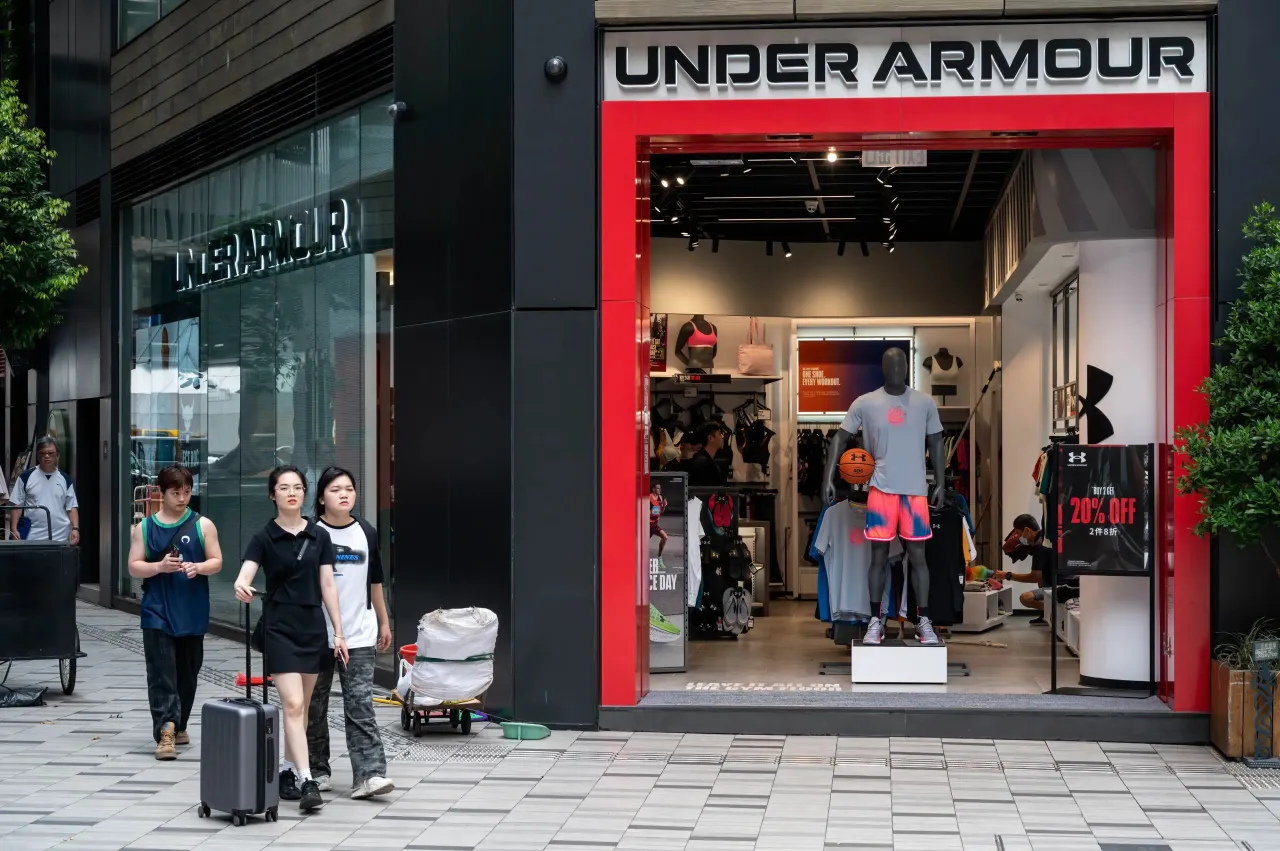 Shoppers walk past an Under Armour store in Hong Kong. (Photo by Sebastian Ng/SOPA Images/LightRocket via Getty Images)