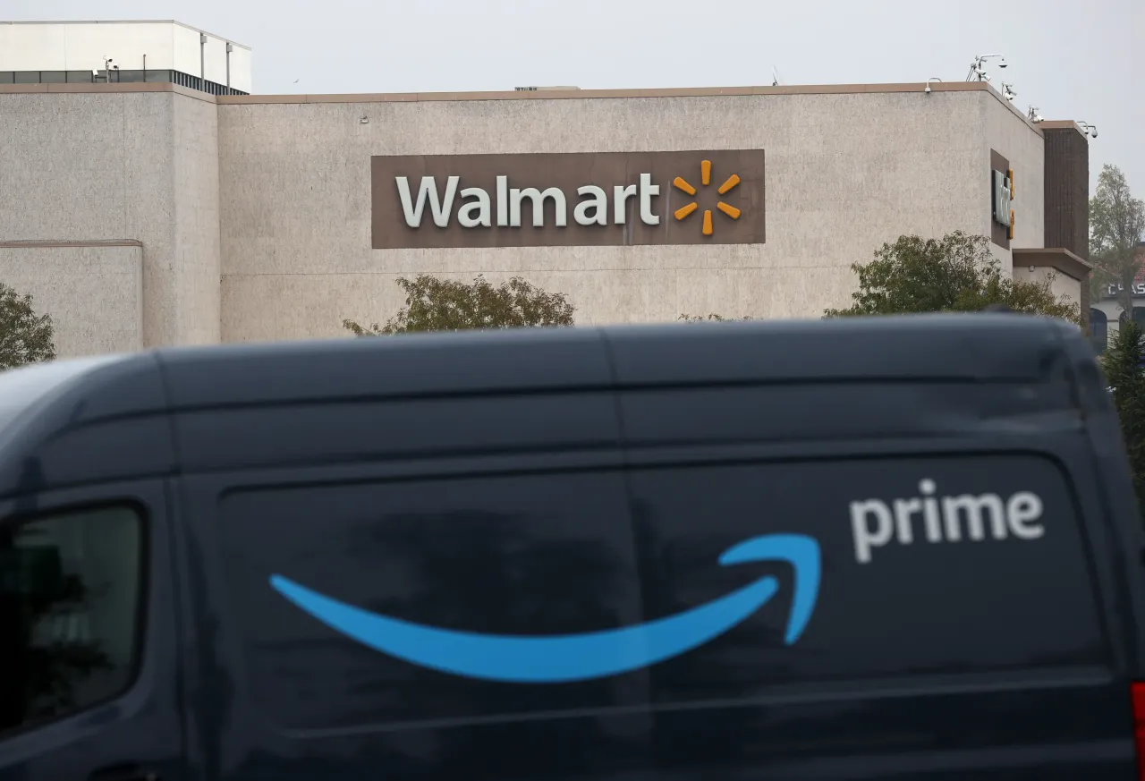 An Amazon Prime delivery van sits parked near a Walmart store in Richmond, California. (Photo by Justin Sullivan/Getty Images)
