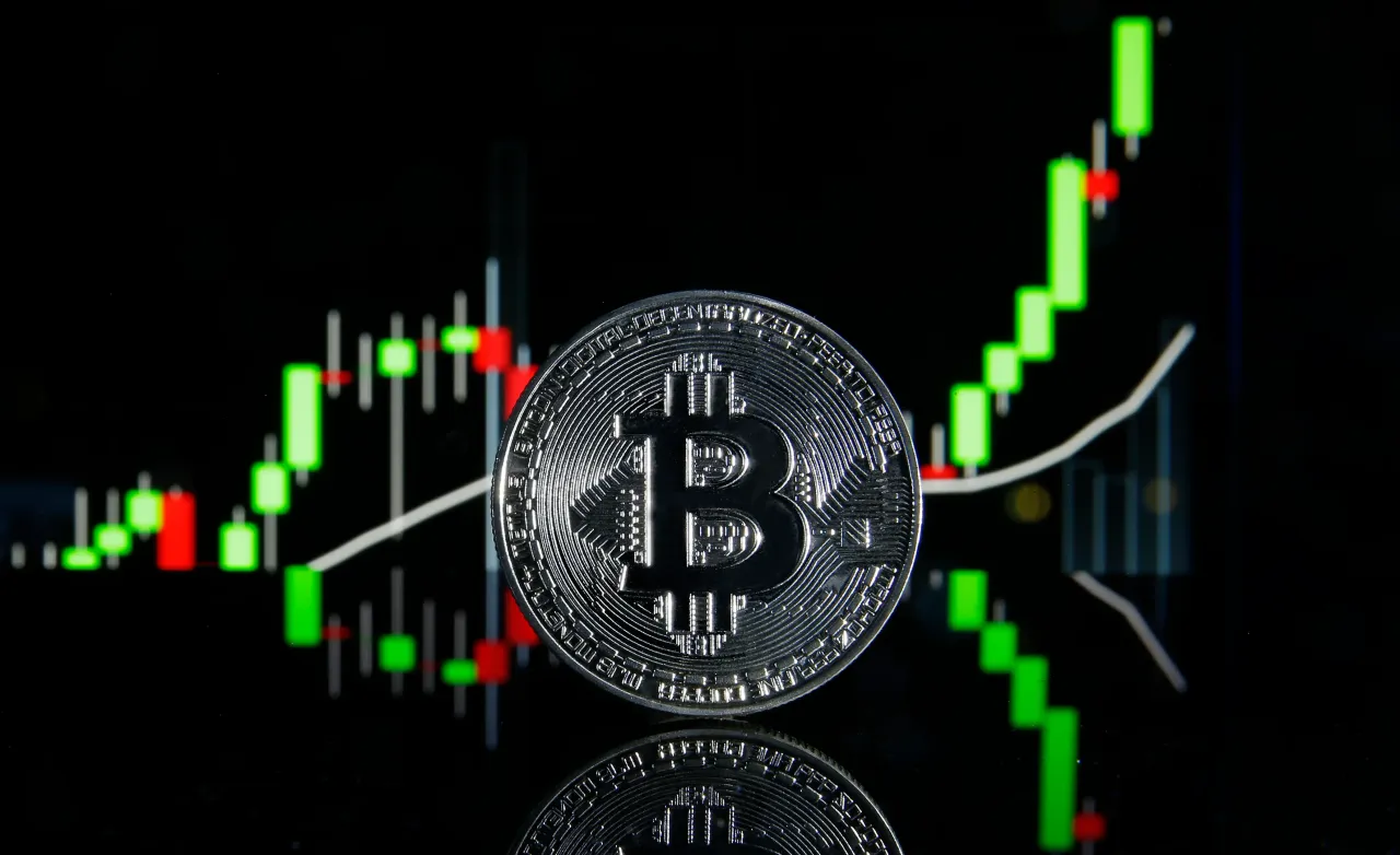 In this photo illustration, a visual representation of the digital Cryptocurrency, Bitcoin is on display in front of the Bitcoin course's graph on January 08, 2021 in Paris, France. (Photo illustration by Chesnot/Getty Images)