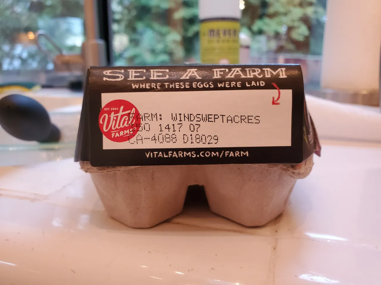 Close-up of a Vital Farms egg carton, with a "See a Farm" stamp stating that the eggs were laid at Windswept Acres Farm, resting on a tiled kitchen countertop in California, January 24, 2021. (Photo by Smith Collection/Gado/Getty Images)