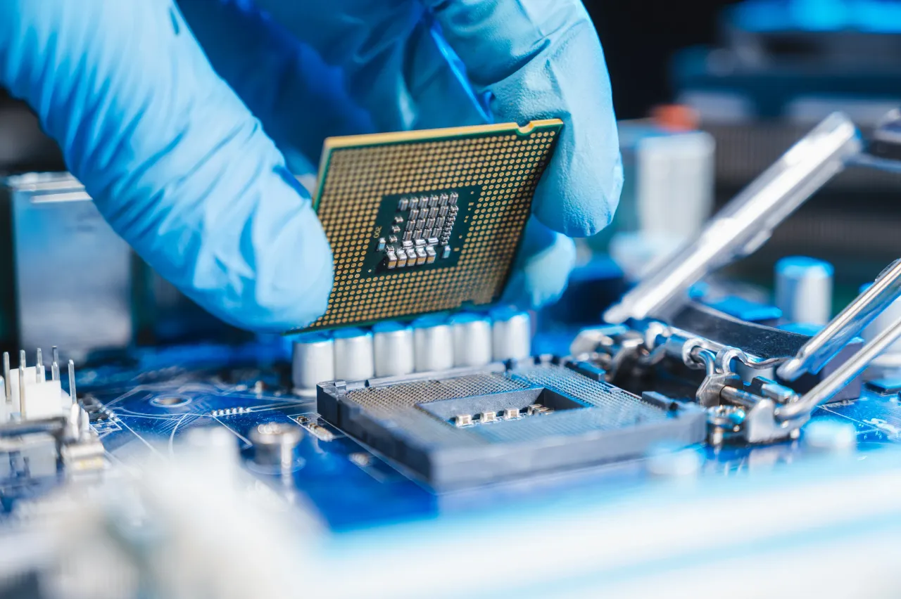 technician laying CPU in the motherboard socket. Major semiconductor stocks gained in Monday's premarket session. (Image source: Getty)