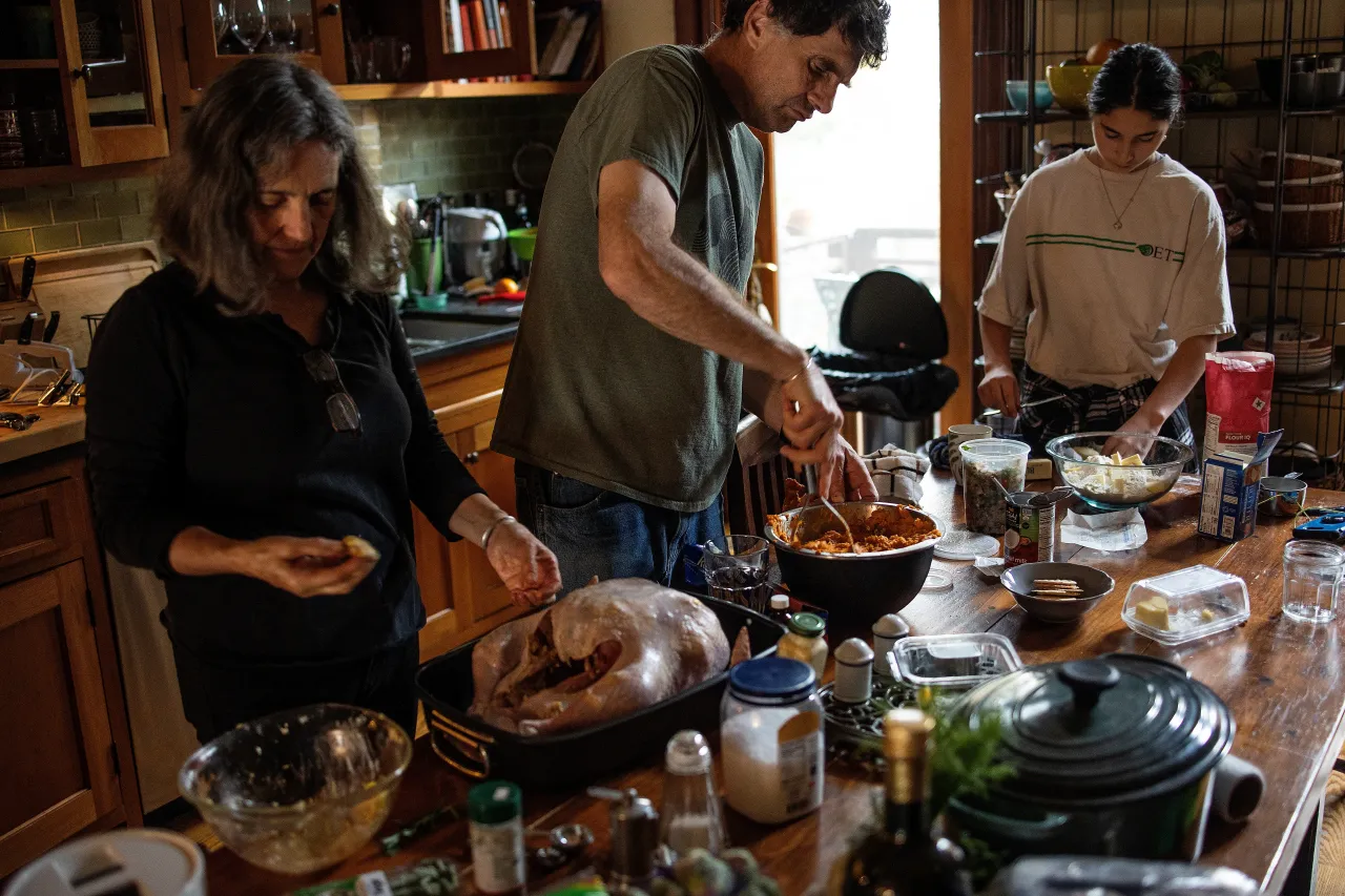 A family preparing a Thanksgiving meal on November 25, 2021 in Brooklyn, New York. (Photo by Andrew Lichtenstein/Corbis via Getty Images)