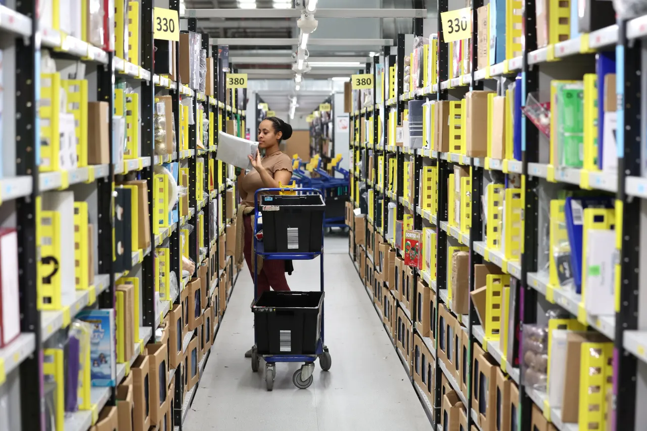 An Amazon employee packs items at Rugeley Amazon Fulfilment Centre on November 23, 2022 in Rugeley, England. (Photo by Nathan Stirk/Getty Images)