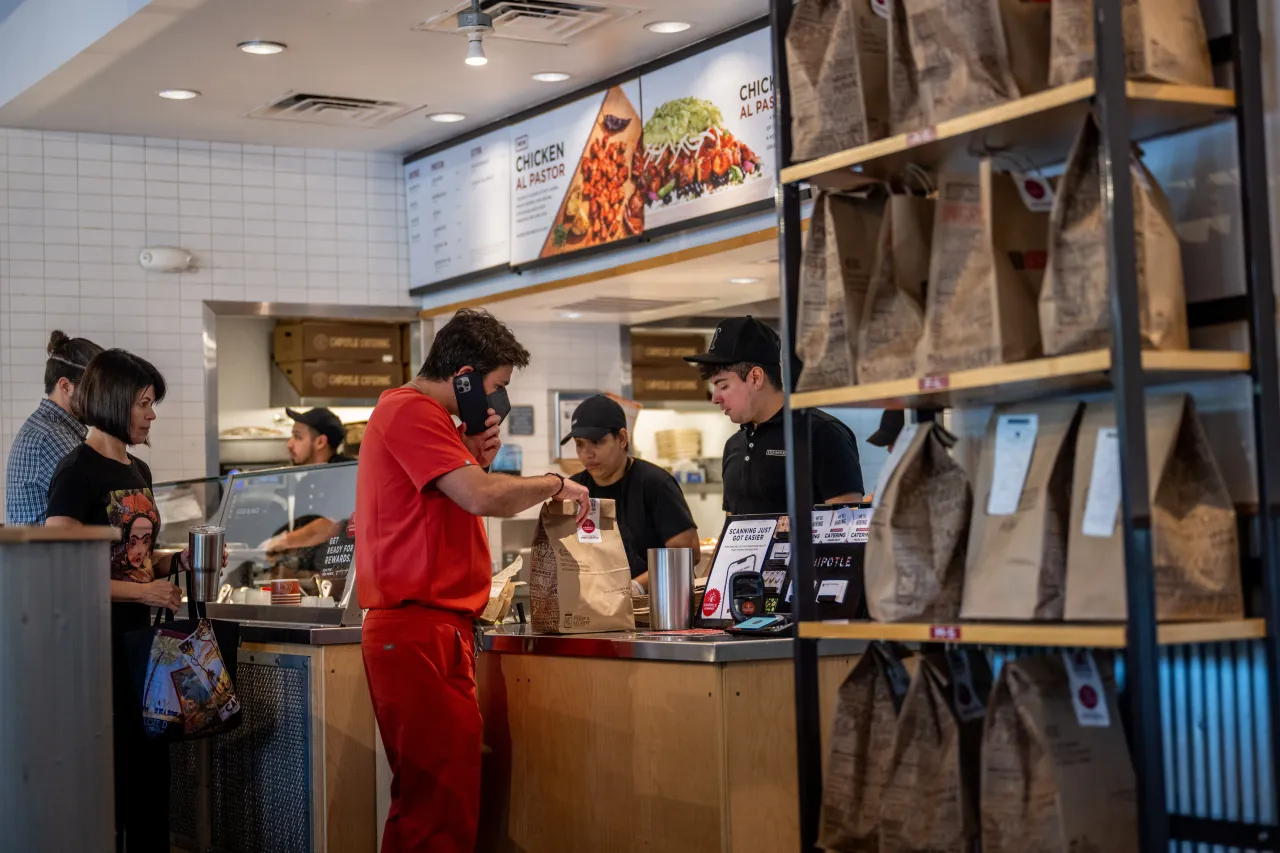 Customers order food at a Chipotle Mexican Grill restaurant on April 26, 2023 in Austin, Texas. (Photo by Brandon Bell/Getty Images)
