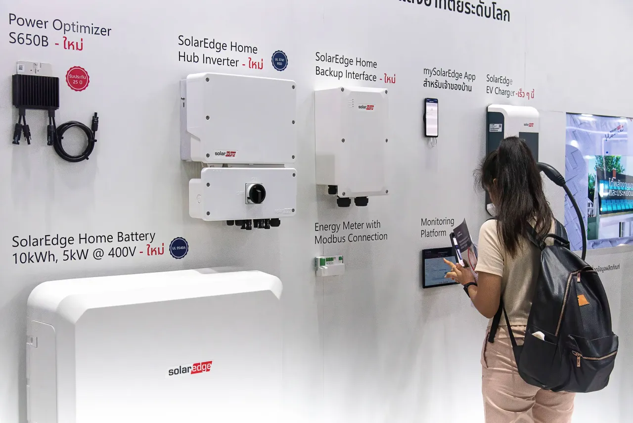 A visitor inspects products at the SolarEdge booth during the event at The Queen Sirikit National Convention Center, in Bangkok, Thailand.