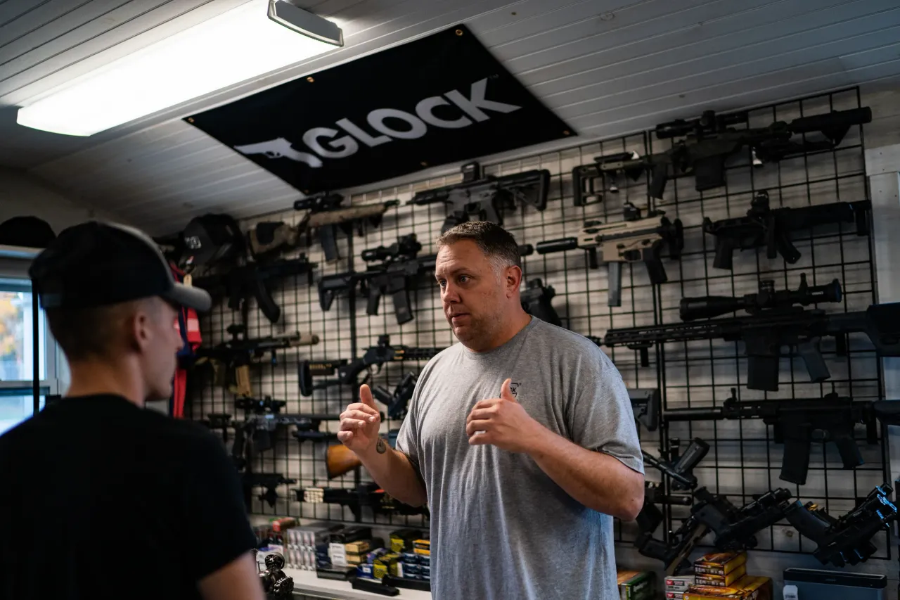 A firearm store owner helps a buyer in n Sabattus, Maine, Friday, October 27, 2023. (Photo by Salwan Georges/The Washington Post via Getty Images)