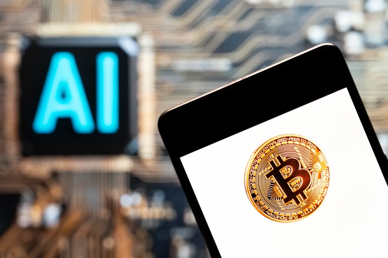 Bitcoin logo seen displayed on a smartphone with an Artificial intelligence (AI) chip (Photo Illustration by Budrul Chukrut/SOPA Images/LightRocket via Getty Images)