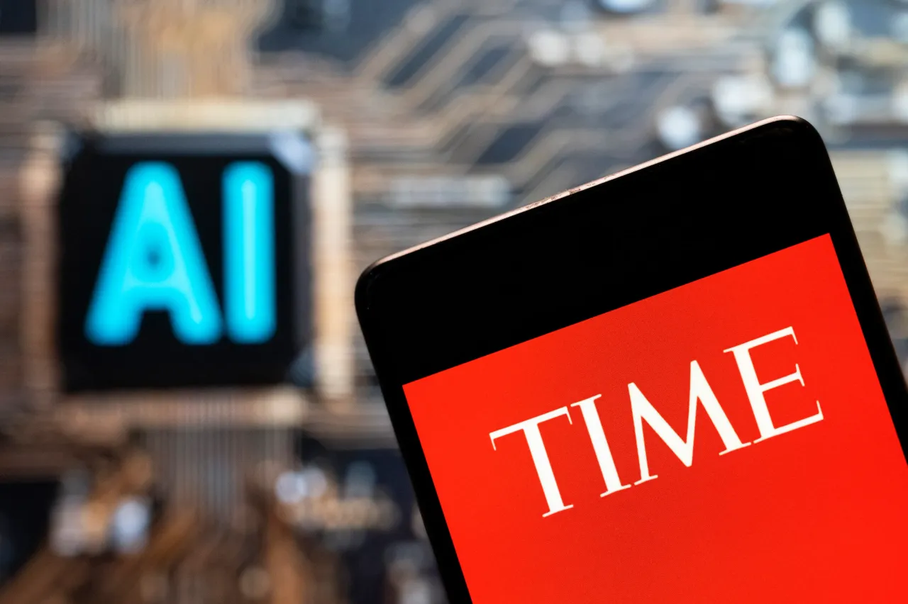 In this photo illustration, the Time logo is seen displayed on a smartphone with an Artificial intelligence (AI) chip and symbol in the background. (Photo Illustration by Budrul Chukrut/SOPA Images/LightRocket via Getty Images)