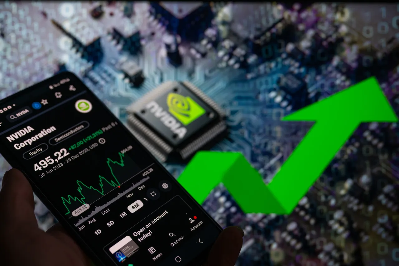A smart phone is displaying the NVIDIA Corporation stock price on the NASDAQ market, with an NVIDIA chip visible in the background. (Photo by Jonathan Raa/NurPhoto via Getty Images)