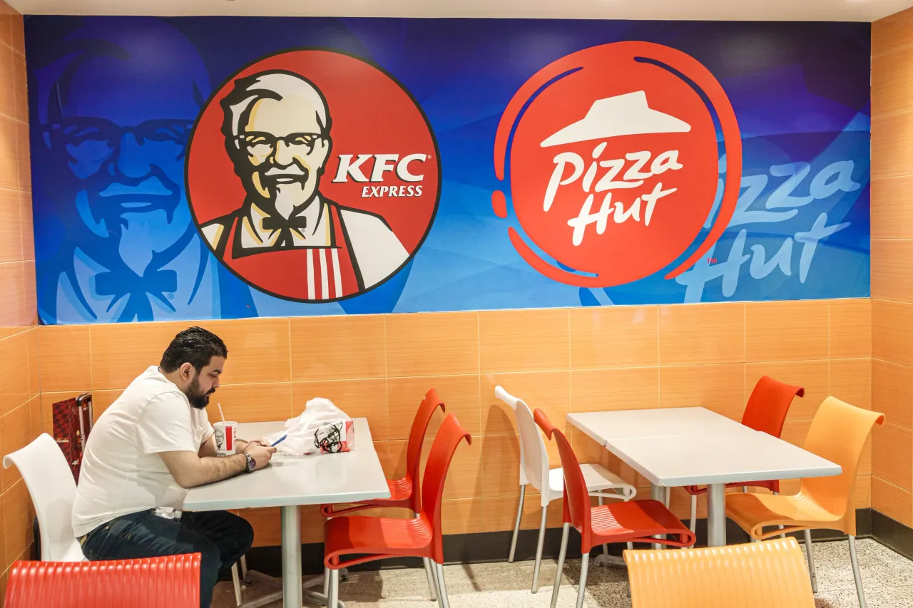 Miami, Florida, Miami International Airport, passenger eating at KFC, Kentucky Fried Chicken Pizza Hut.