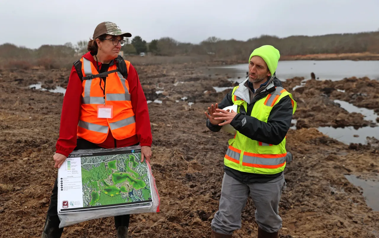 Karen Beattie, Vice President of Science & Stewardship of the Nantucket Conservation Foundation, listens to Michael Soares, a wetland scientist. (Photo by David L. Ryan/The Boston Globe via Getty Images)