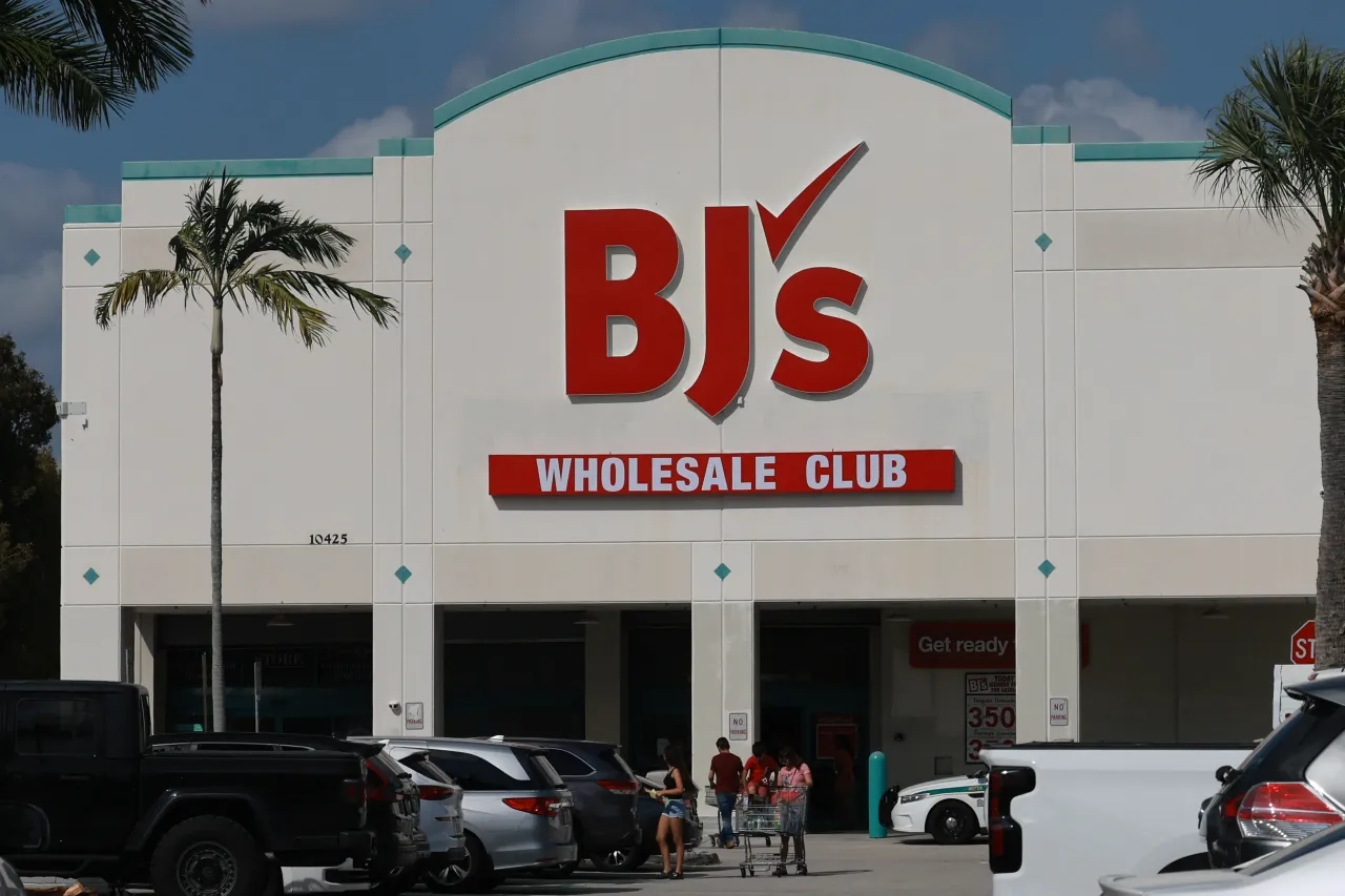 People walk near the front entrance to a BJ's Wholesale Club store in Miami, Florida.