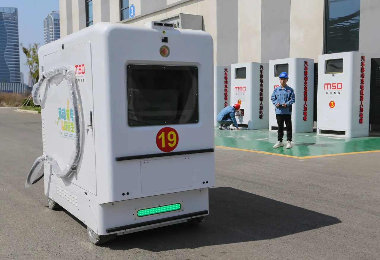 A technician remotely operates a mobile charging robot in Lianyungang, Jiangsu province, China.