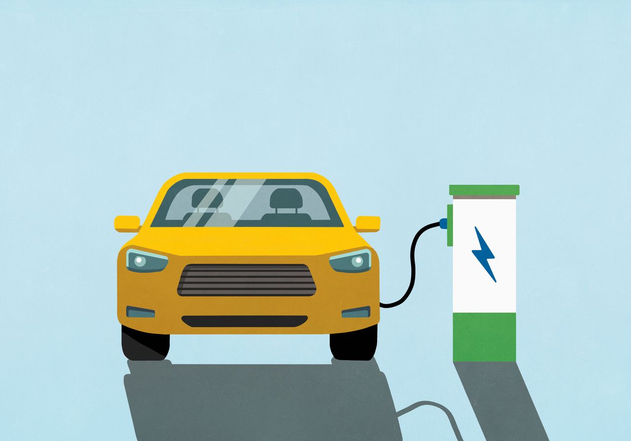 Yellow electric car charging at electric charging station. Source: Getty Images