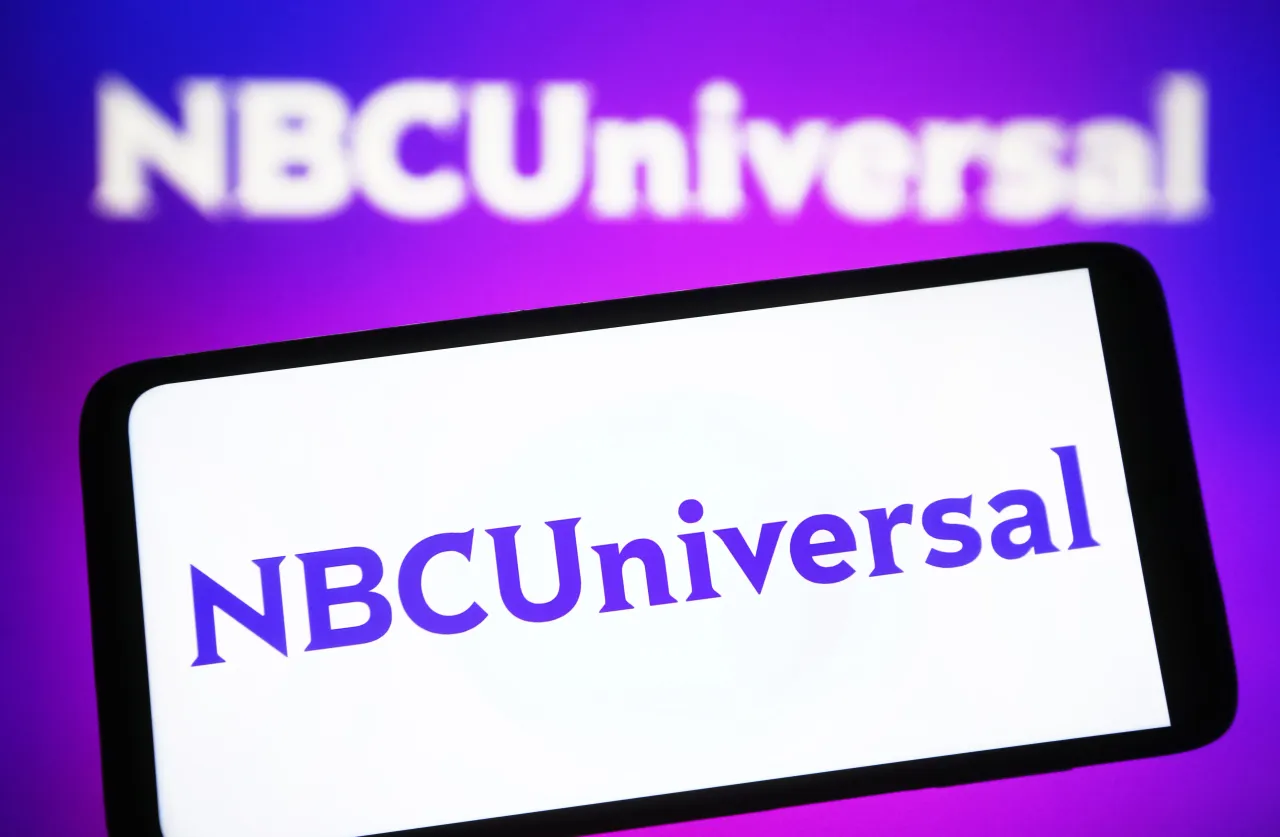 In this photo illustration, the NBCUniversal logo is seen on a smartphone and in the background. (Photo Illustration by Pavlo Gonchar/SOPA Images/LightRocket via Getty Images)