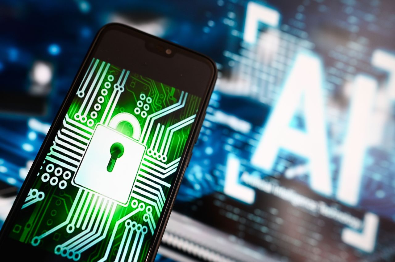 A data lock illustration is displayed on a smartphone with AI symbol in the background. (Photo Illustration by Omar Marques/SOPA Images/LightRocket via Getty Images)