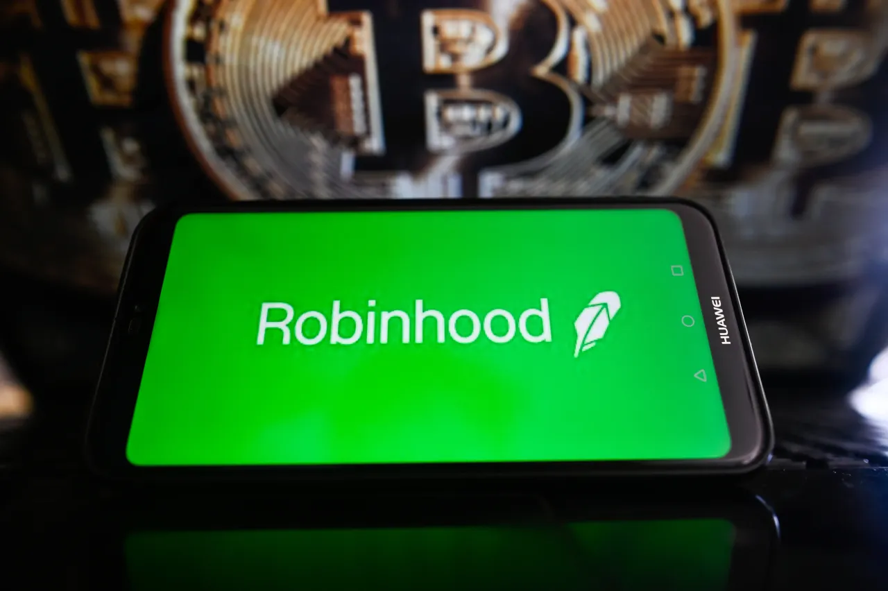 In this photo illustration, a Robinhood logo is displayed on a smartphone with Bitcoin logo in the background. (Photo Illustration by Omar Marques/SOPA Images/LightRocket via Getty Images)