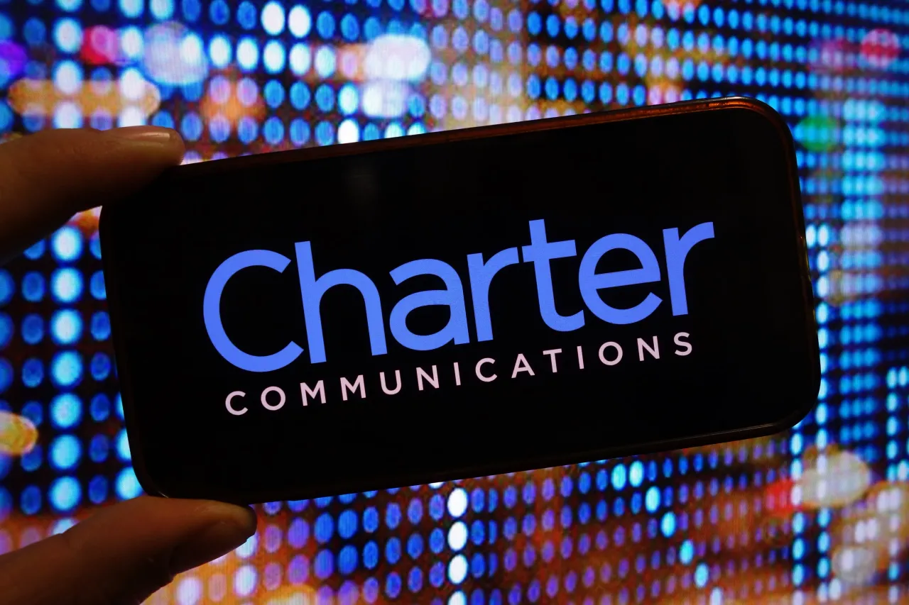  In this photo illustration, the Charter Communications company logo is seen displayed on a smartphone screen. 