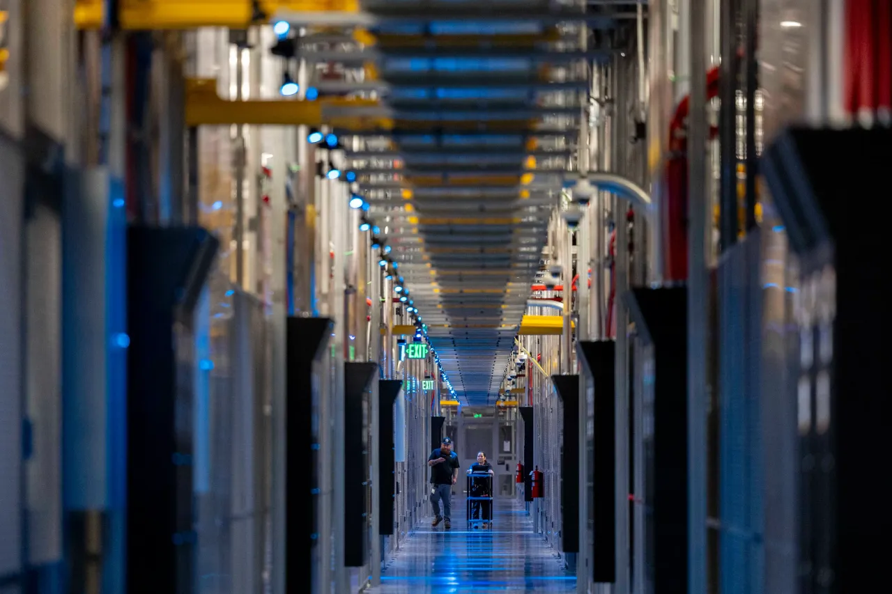 People walk through the hallways at Equinix Data Center in Ashburn, Virginia, on May 9, 2024. (Amanda Andrade-Rhoades for The Washington Post via Getty Images)