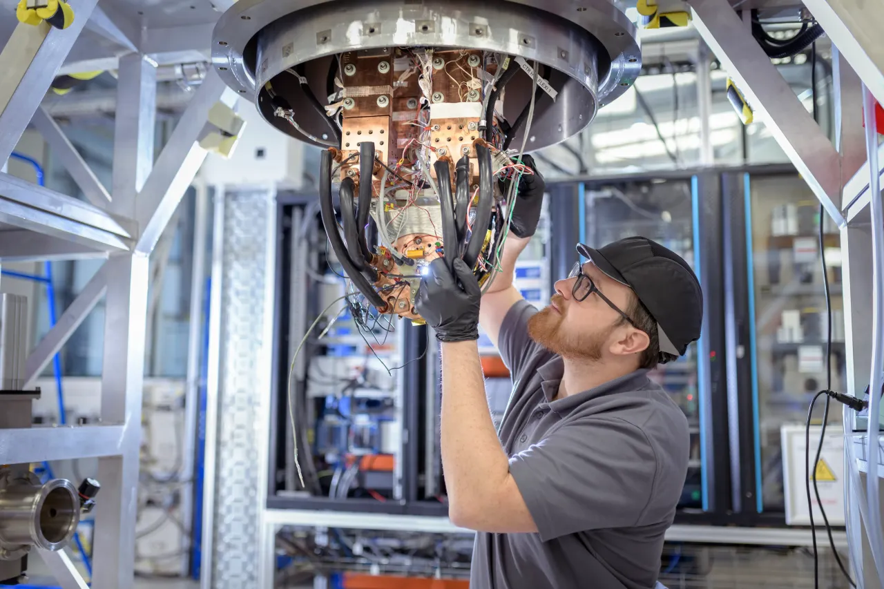 An engineer assembling a high-temperature superconducting magnet inside a Nuclear Fusion reactor. General Fusion's listing comes amid surging electricity demand driven by the AI boom. (Representative Image via Getty Images)
