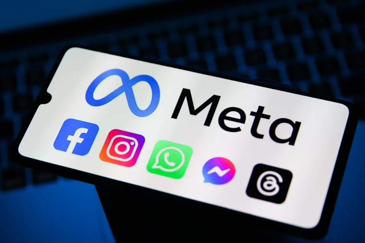 Meta logo and logos of Facebook, Instagram, WhatsApp, Messenger and Threads are screened on a mobile phone.