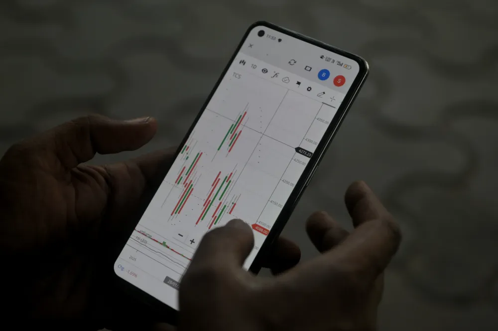 A man browses a stock market app during the union budget announcement by Nirmala Sitharaman at the Bombay Stock Exchange headquarters in Mumbai, India, on February 1, 2025. (Photo by Indranil Aditya/NurPhoto via Getty Images)