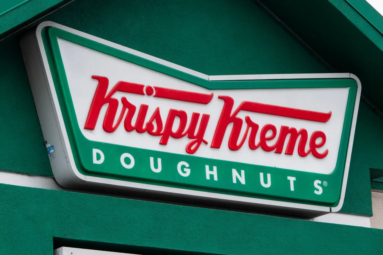 The Krispy Kreme corporate logo is displayed on a sign at their store on January 31, 2025 in San Diego, California. (Photo by Kevin Carter/Getty Images)